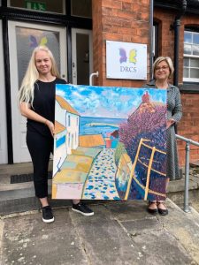 Painting gift – artist Kelly Herrick and DRCS’s Janette Smeeton.